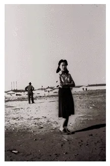 Woman in dust with camp in background