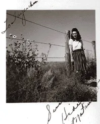 Friends posing by barbed wire fence